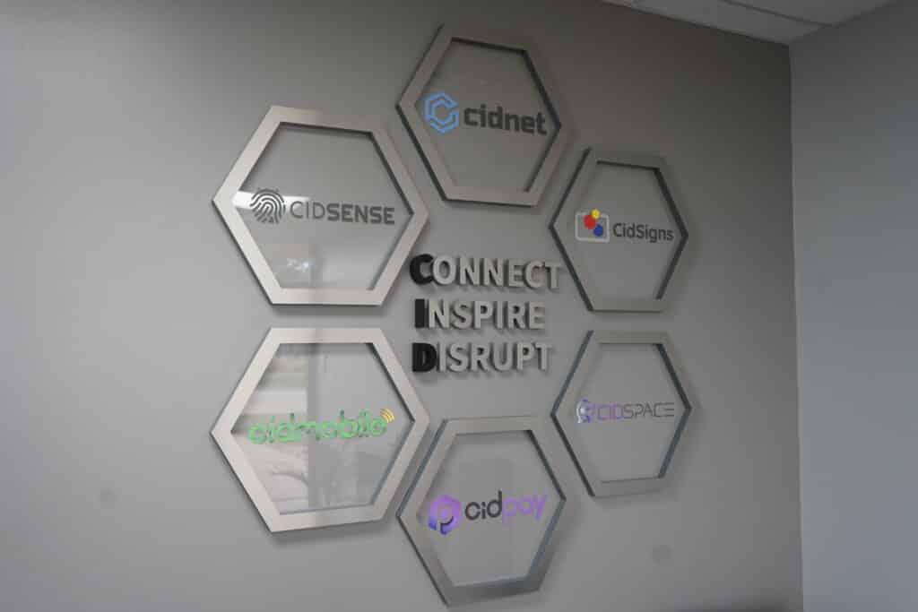A wall featuring a prominent sign that reads "Connect Inspire" in bold letters.